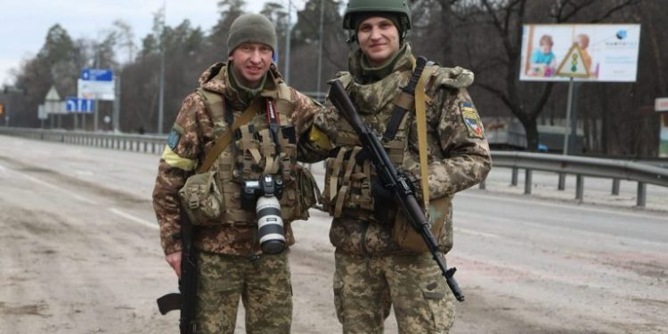 Volodymyr Fitio (on the left) with his colleague Denys Brui near Stoyanka in the Kyiv Region on March 3, 2022