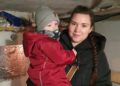 Chernihiv. Oleksandra Martynenko, with her son, goes to a shelter set up by neighbors Roman Yarylovets and his brother Viyacheslav during an air raid alert. Photo by Vist (Chernihiv)