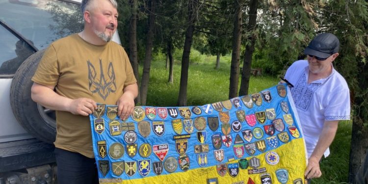British volunteers are coming to Ukraine for the 36th time. The flag features the chevrons of the units they helped. Photo provided by Oleksii Pasiuha